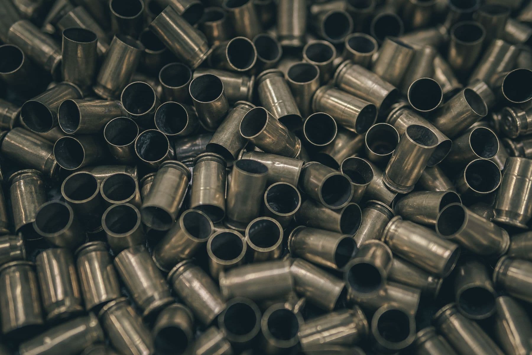 Spent brass cases piled together, photographed close