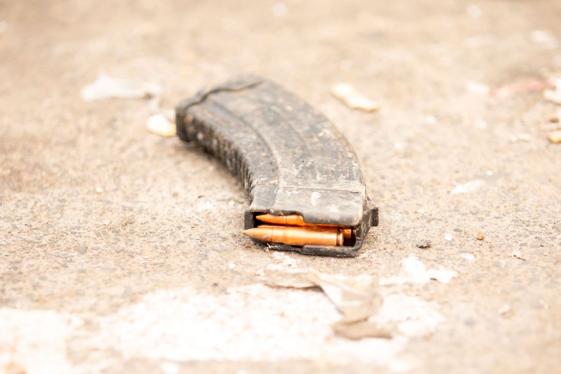 A loaded AR magazine lying on concrete
